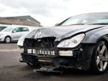 Detail Of Car Damaged In Motor Vehicle Accident Parked In Garage Repair Shop